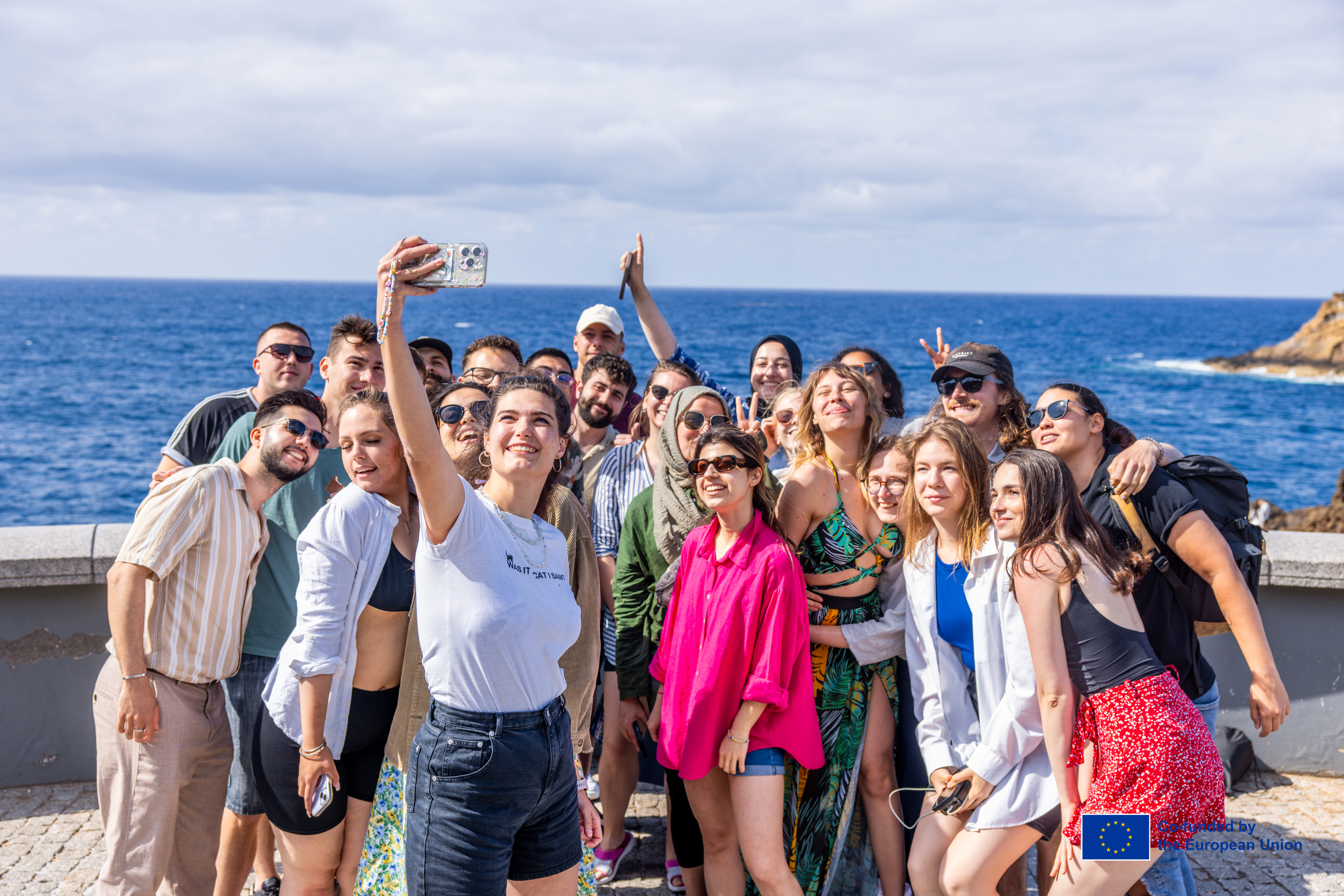 Group of youth participants gathered beside the sea in Madeira